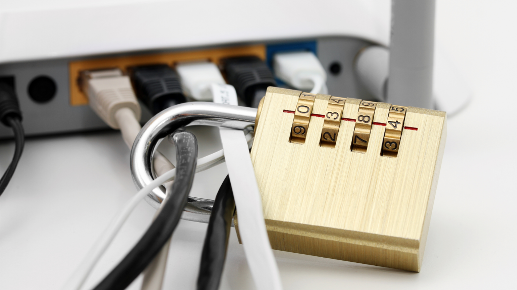 Im Vorderrung hält das Schlos diverse Kabel, welche zu einem Router führen fest. 